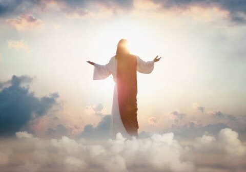 The resurrected Jesus Christ ascending to heaven above the bright light sky and clouds and God, Heaven and Second Coming concept